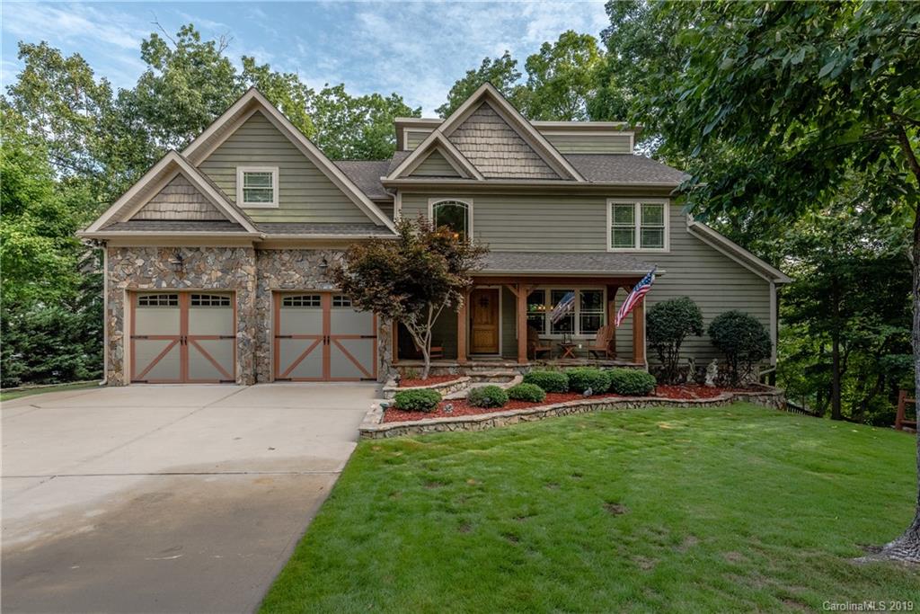 10023 Bora Bora Drive Tega Cay, SC 29708 - Photo 6 of 32 a front view of a house with a garden and trees