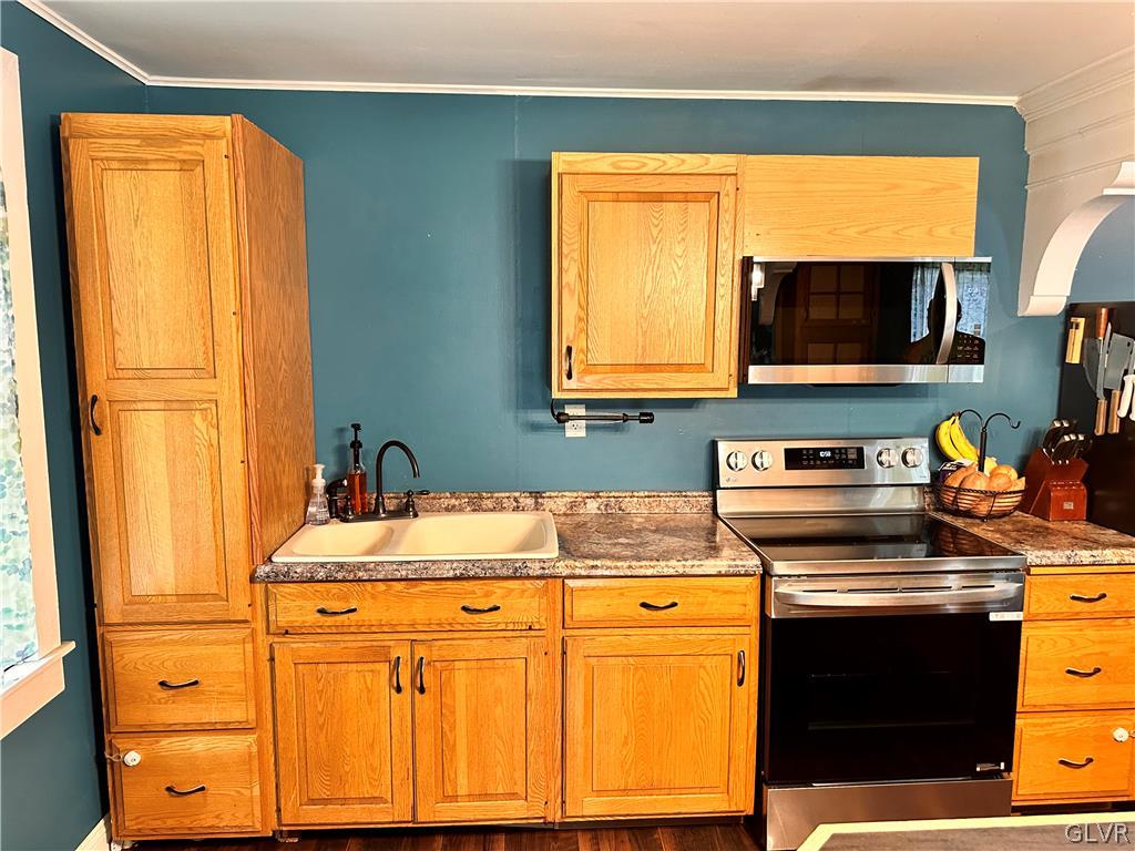 8547 Deer Road Slatington, PA 18080 - Photo 11 of 32 a kitchen with stainless steel appliances white cabinets and a stove top oven