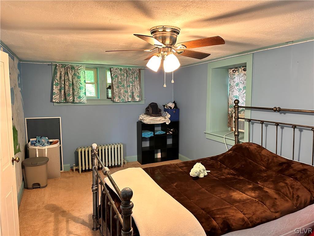 8547 Deer Road Slatington, PA 18080 - Photo 25 of 32 a bedroom with a bed and a chandelier