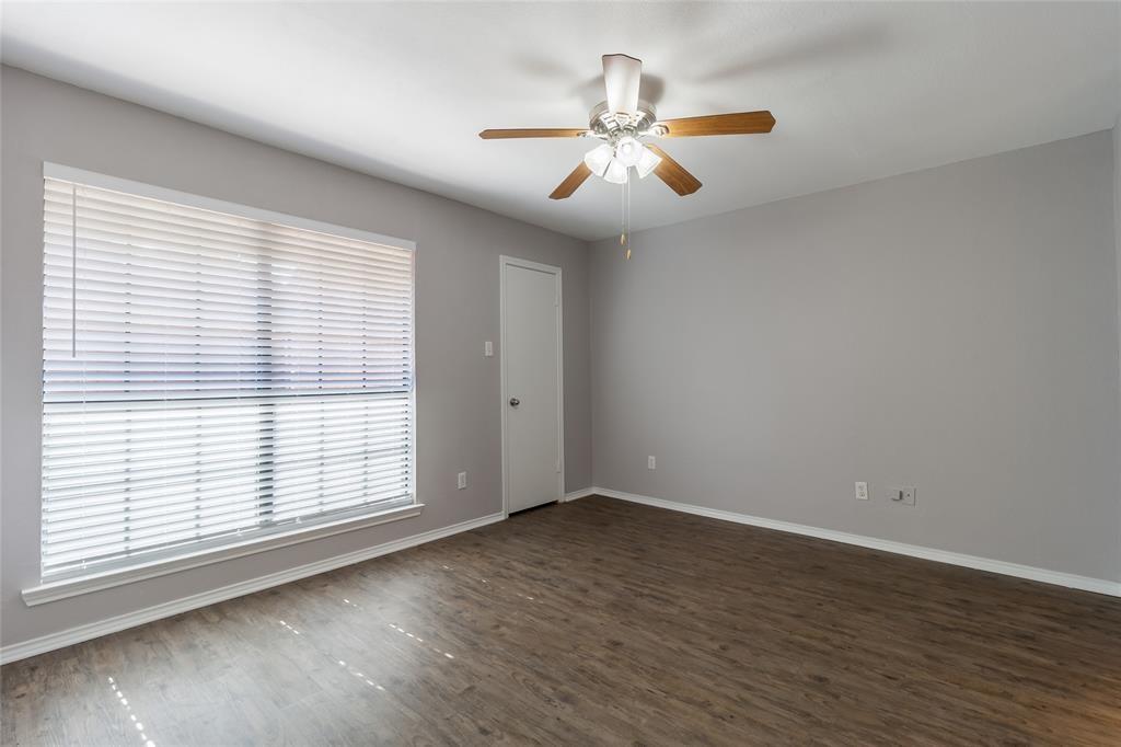 449 Harris Street, Unit 103C Coppell, TX 75019 - Photo 11 of 17 Downstairs bedroom with ceiling fan and beautiful flooring