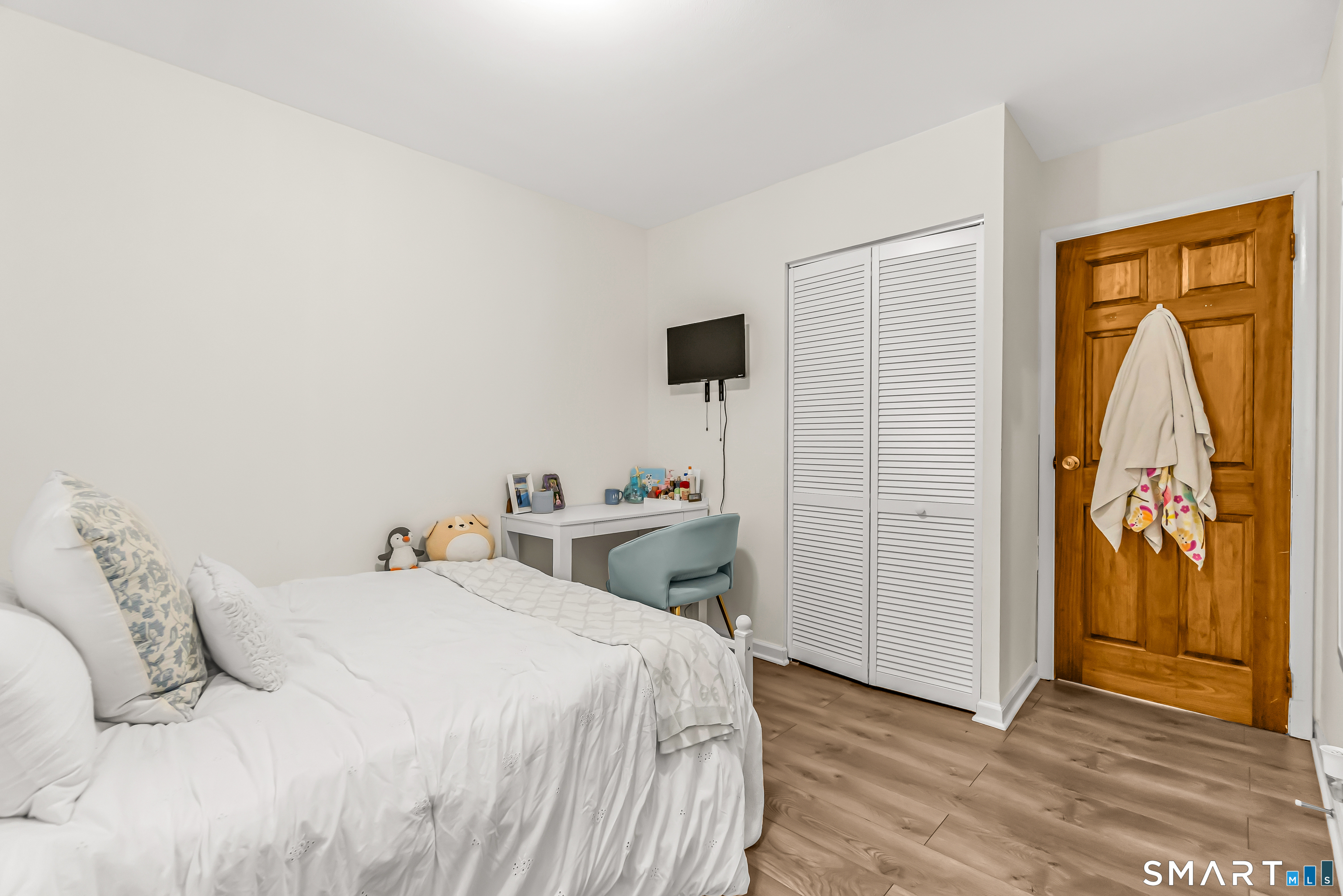 252 Bear Paw Road Bridgeport, CT 06606 - Photo 12 of 25 a bedroom with a bed and wooden floor