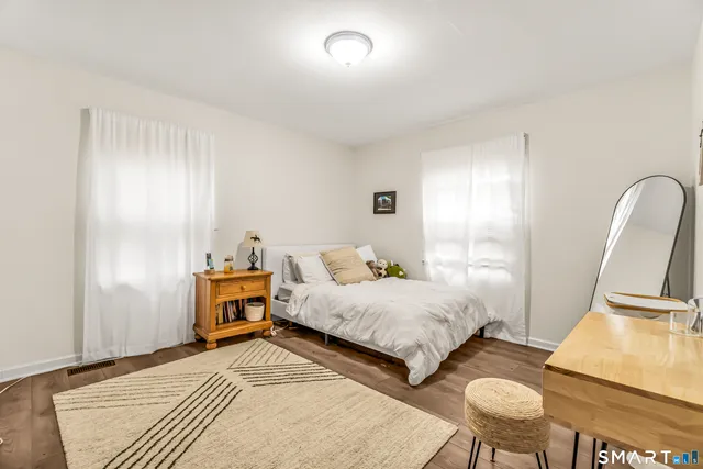 a bedroom with bed and a night stand