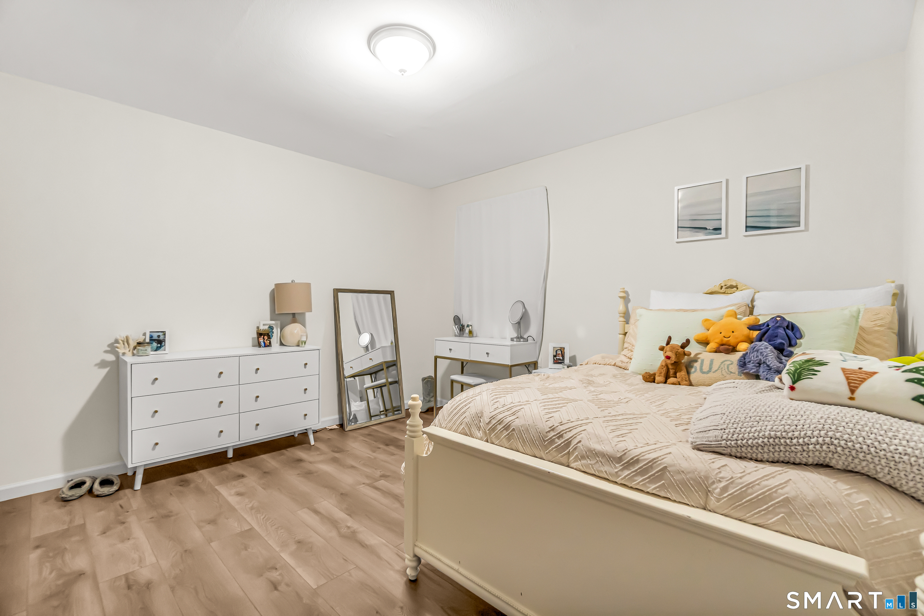 252 Bear Paw Road Bridgeport, CT 06606 - Photo 18 of 25 a bedroom with a bed and wooden floor