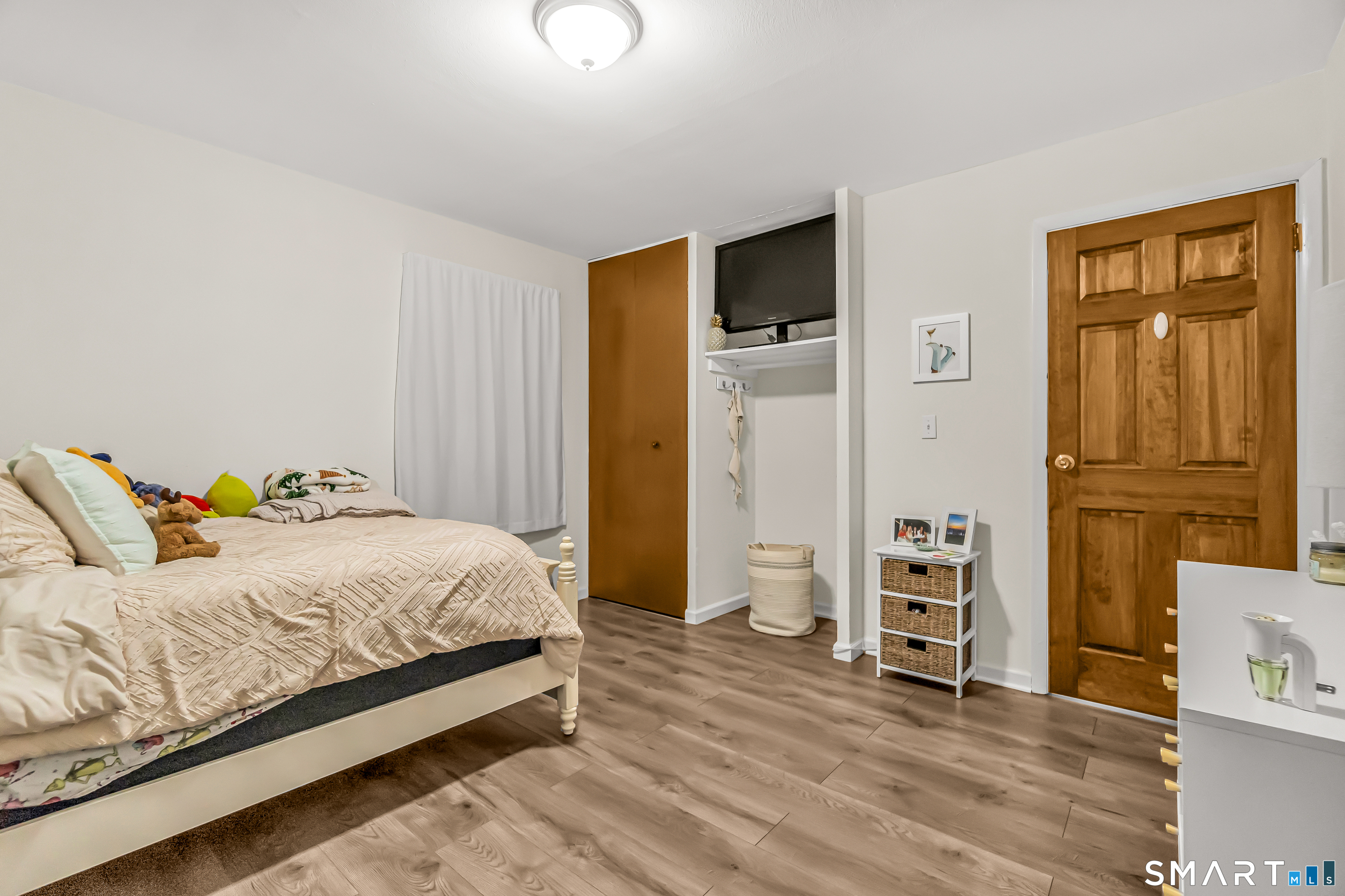 252 Bear Paw Road Bridgeport, CT 06606 - Photo 19 of 25 a bedroom with a bed and a television