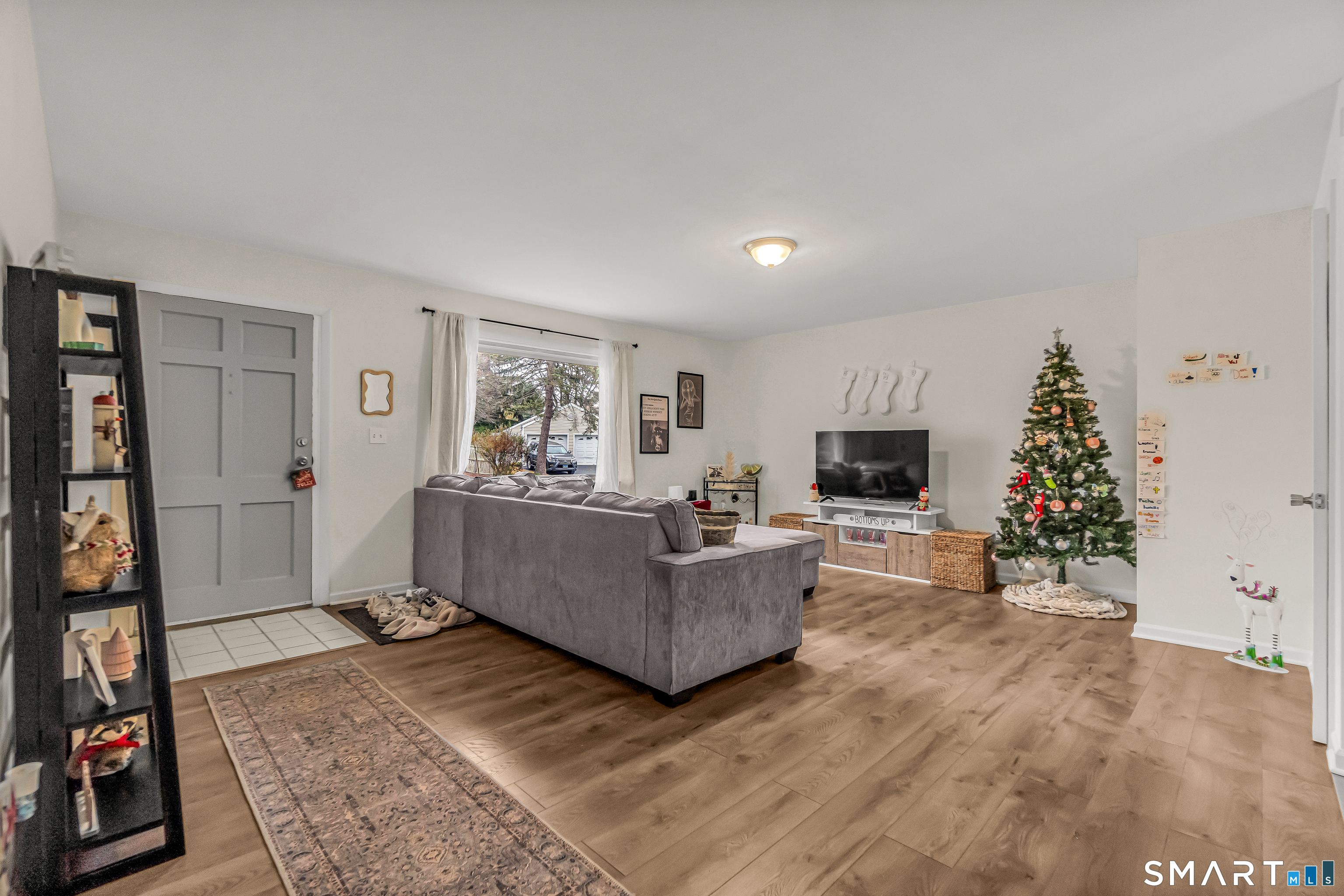 252 Bear Paw Road Bridgeport, CT 06606 - Photo 2 of 25 a living room with furniture and a flat screen tv
