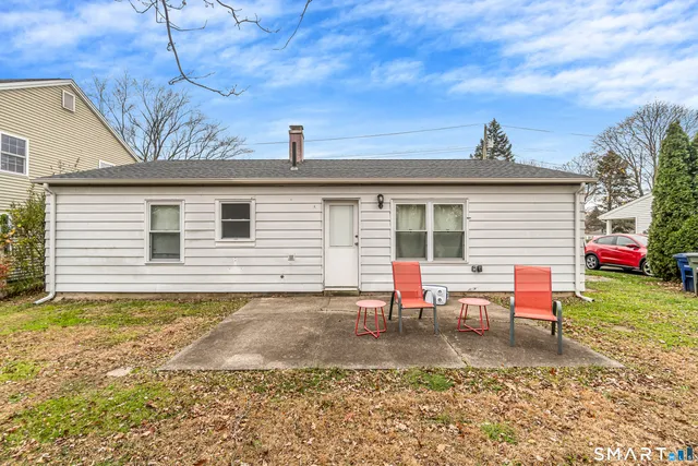 a backyard of a house with outdoor seating