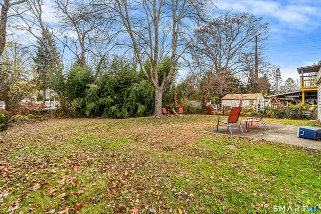 a view of yard with swimming pool and seating area