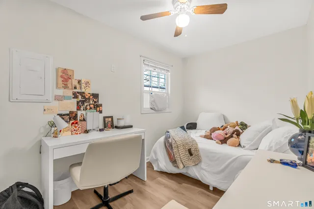 a bedroom with a bed and a table chair