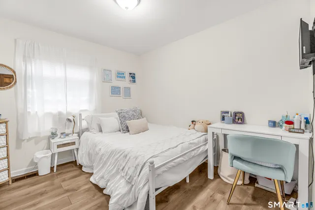 a bedroom with a bed and a desk