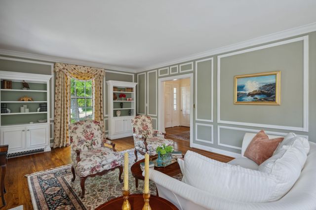 a kitchen with granite countertop stainless steel appliances a refrigerator sink and wooden cabinets