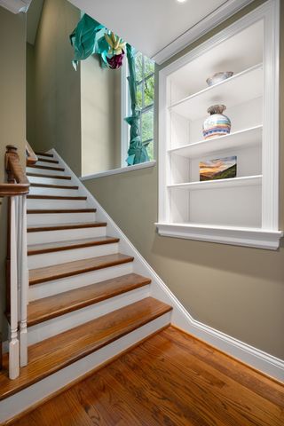a balcony with chairs and wooden floor