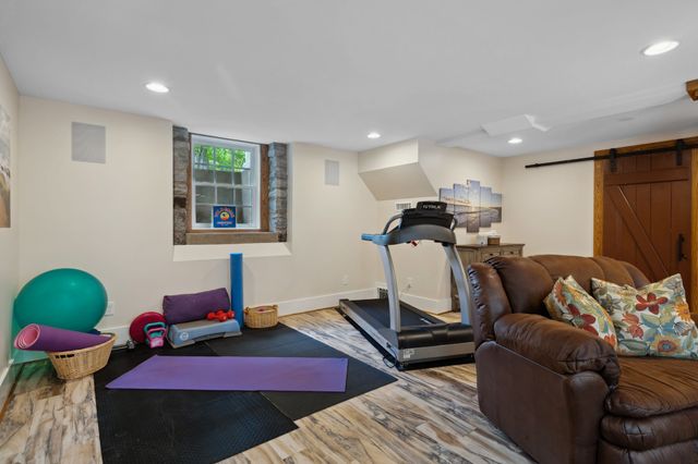 an aerial view of residential house with outdoor space and trees all around