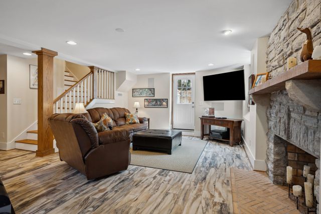 a view of a brick house with a large windows and large trees