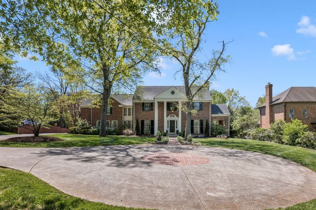 a view of a house with potted plants