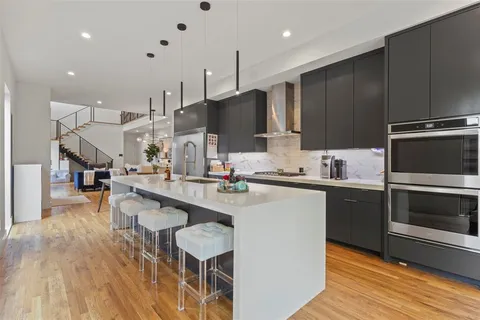 a kitchen with kitchen island granite countertop a sink counter top space stainless steel appliances and cabinets