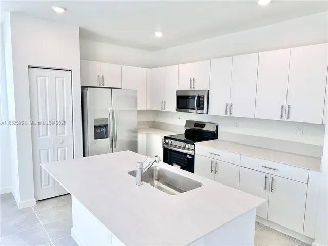 a view of kitchen with sink and window