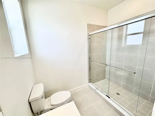 a view of an empty room and a window