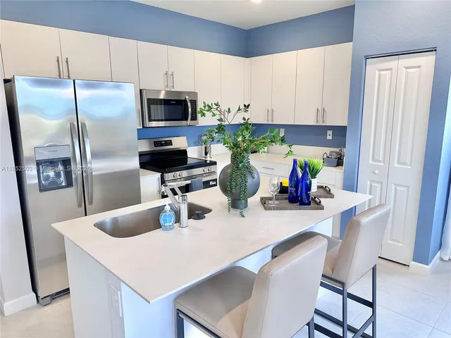 a living room filled with furniture and a chandelier