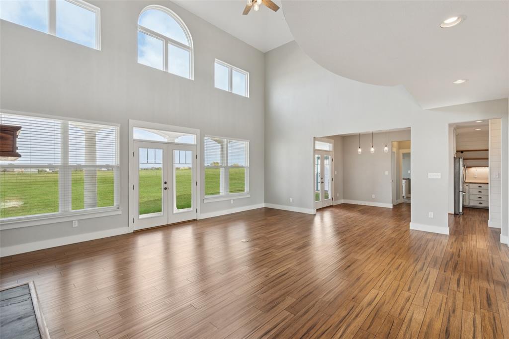 155 North Armstrong Road Venus, TX 76084 - Photo 12 of 38 a view of an empty room with wooden floor and a window