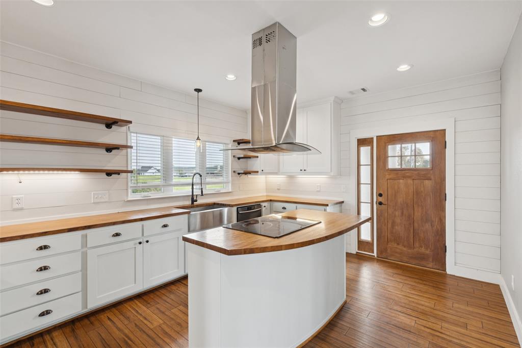 155 North Armstrong Road Venus, TX 76084 - Photo 14 of 38 a kitchen with sink a stove and cabinets