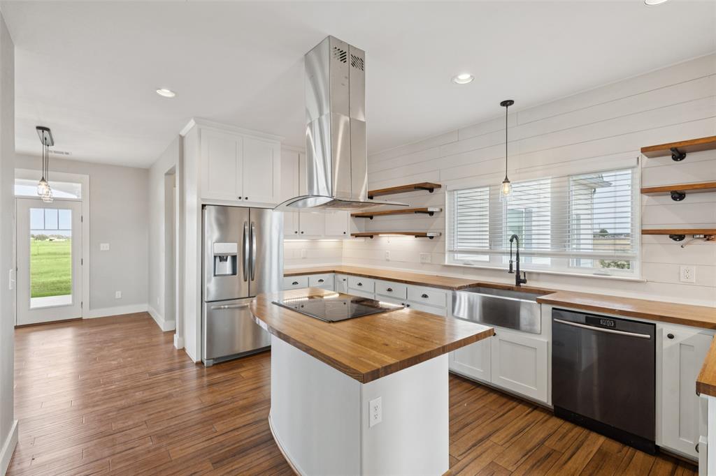 155 North Armstrong Road Venus, TX 76084 - Photo 15 of 38 a kitchen with stainless steel appliances granite countertop a sink and a refrigerator