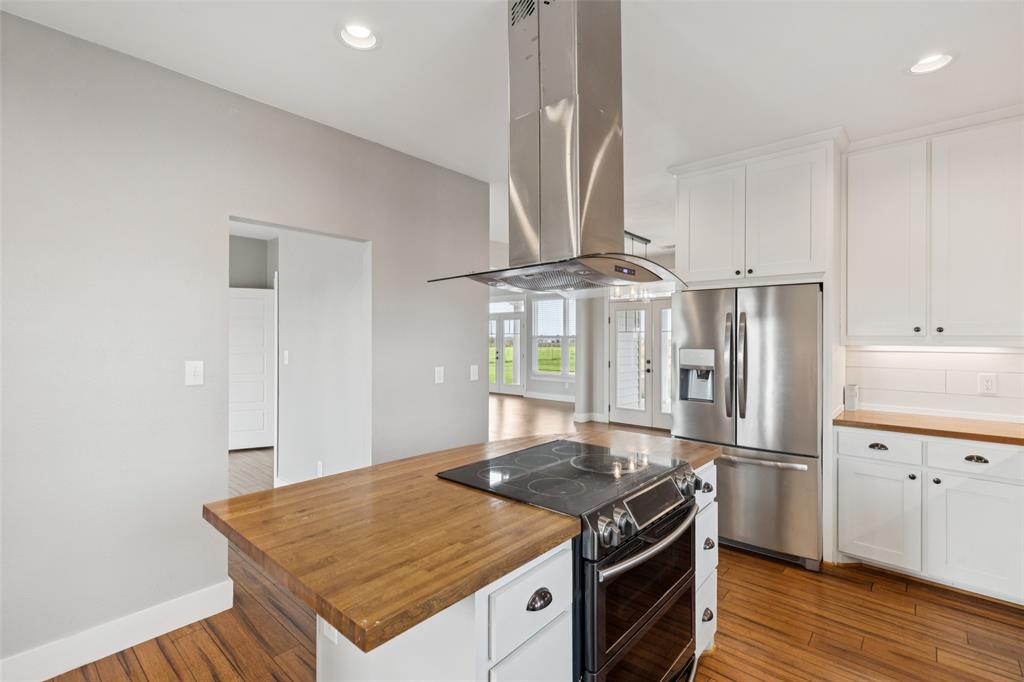 155 North Armstrong Road Venus, TX 76084 - Photo 16 of 38 a kitchen with stainless steel appliances granite countertop a stove a refrigerator and a sink