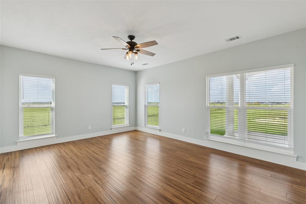 155 North Armstrong Road Venus, TX 76084 - Photo 17 of 38 a view of an empty room with wooden floor and a window