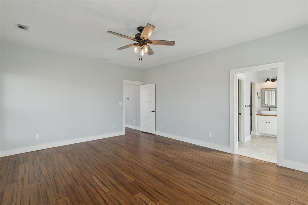155 North Armstrong Road Venus, TX 76084 - Photo 19 of 38 a view of an empty room with wooden floor and a ceiling fan