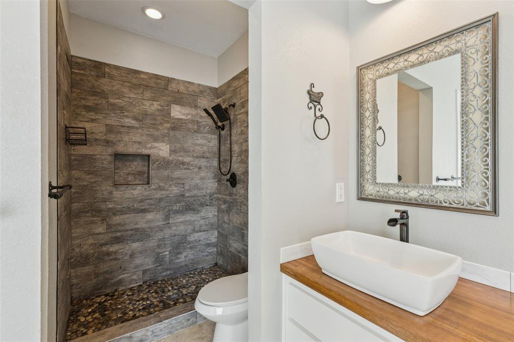 155 North Armstrong Road Venus, TX 76084 - Photo 21 of 38 a bathroom with a sink a toilet and shower