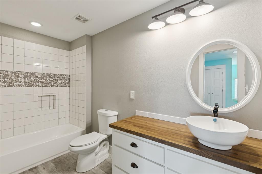 155 North Armstrong Road Venus, TX 76084 - Photo 23 of 38 a bathroom with a granite countertop sink a toilet and bathtub