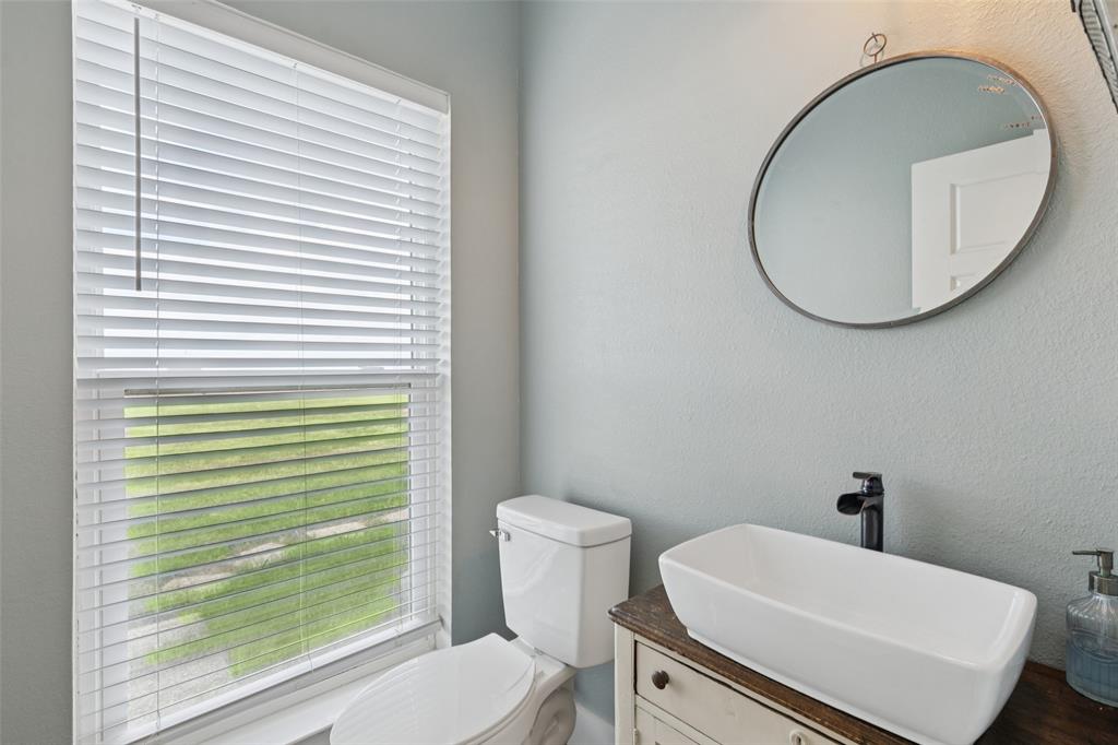 155 North Armstrong Road Venus, TX 76084 - Photo 29 of 38 a bathroom with a sink a toilet and a mirror
