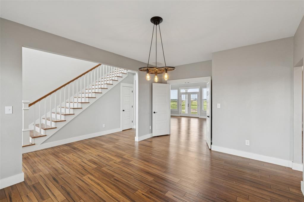 155 North Armstrong Road Venus, TX 76084 - Photo 5 of 38 a view of an empty room with wooden floor and a window