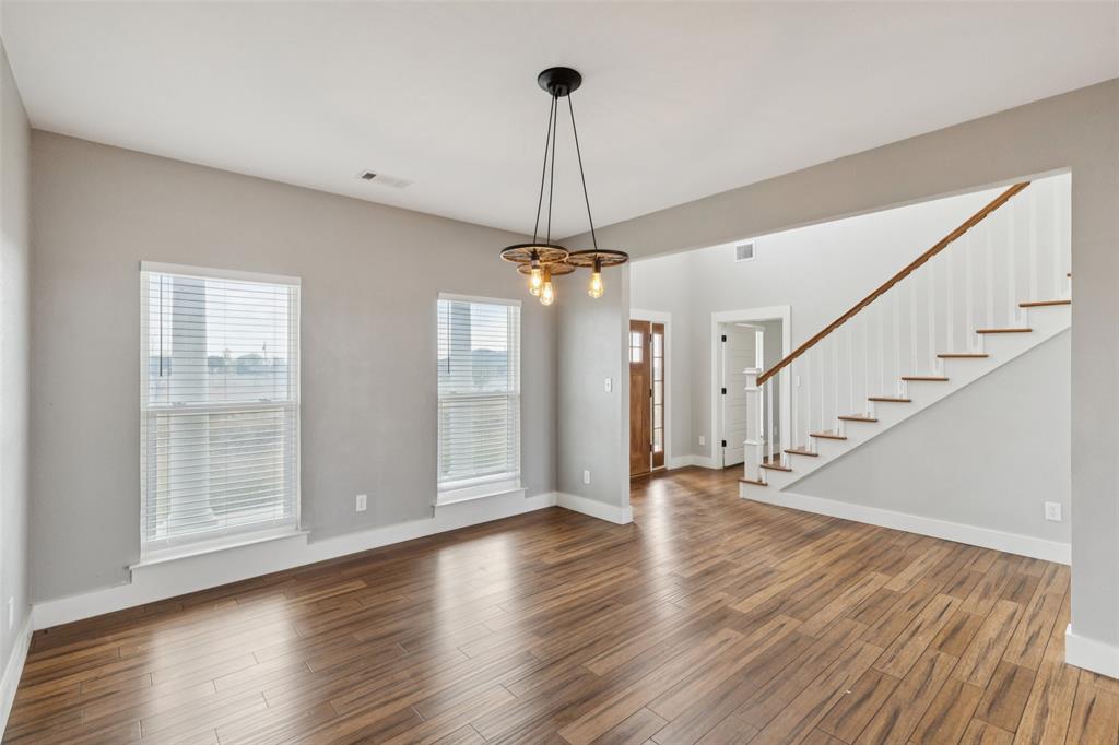 155 North Armstrong Road Venus, TX 76084 - Photo 7 of 38 a view of a room with wooden floor chandelier and windows