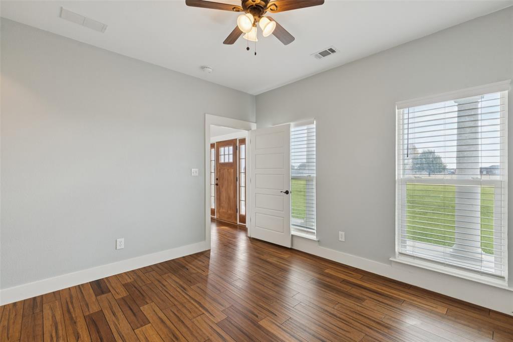 155 North Armstrong Road Venus, TX 76084 - Photo 8 of 38 a view of an empty room with a window and wooden floor