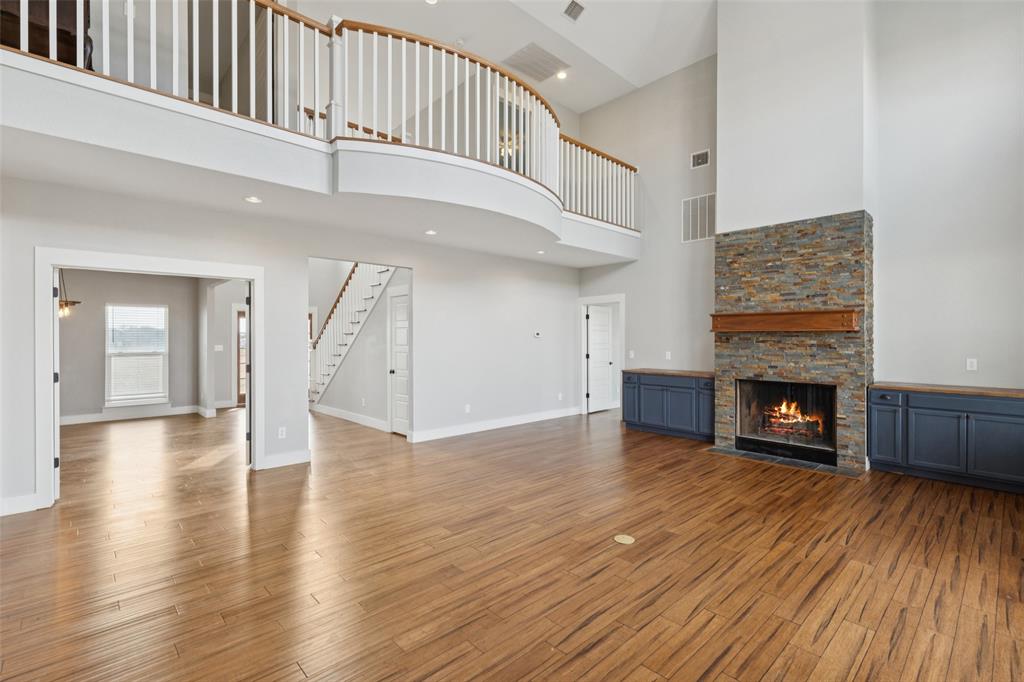 155 North Armstrong Road Venus, TX 76084 - Photo 9 of 38 a view of an empty room with wooden floor fireplace and a window