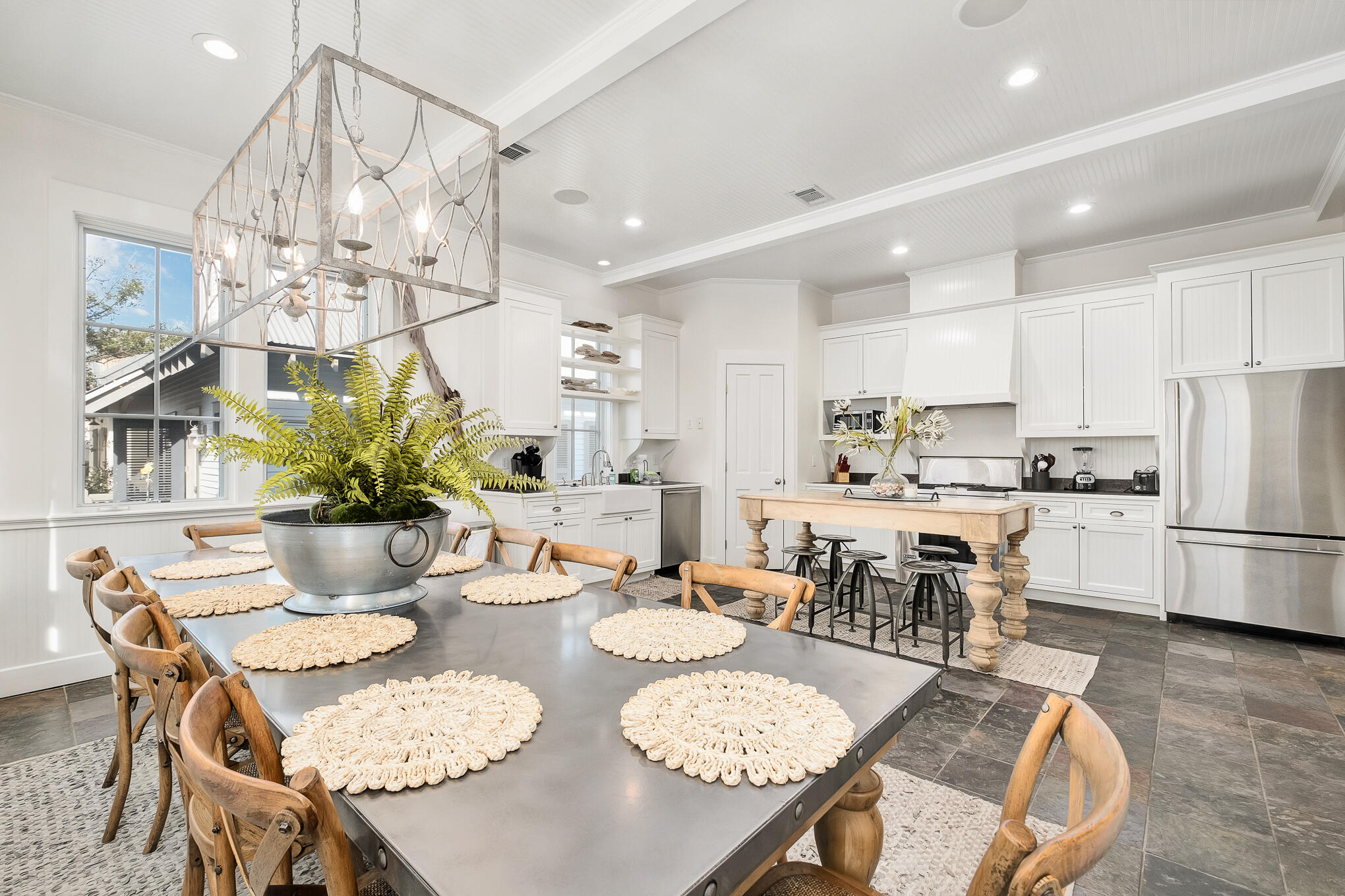 144 Round Rd Inlet Beach Inlet Beach, FL 32461 - Photo 12 of 56 a kitchen with stainless steel appliances kitchen island granite countertop a dining table chairs and white cabinets