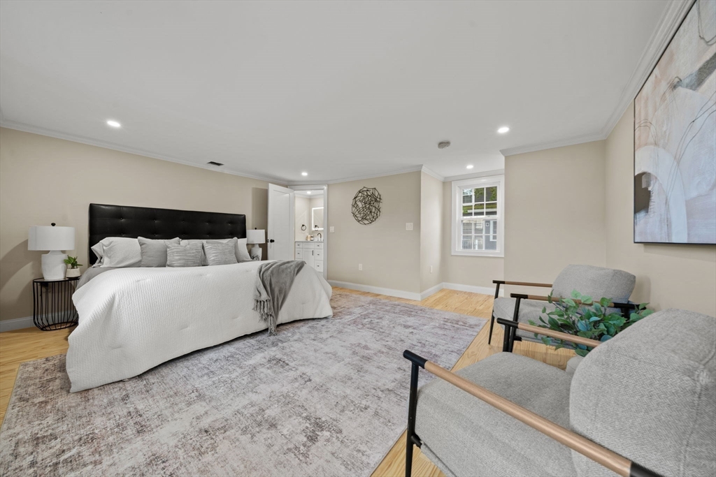 162 High Street, Unit B Danvers, MA 01923 - Photo 15 of 32 a bedroom with a bed and wooden floor