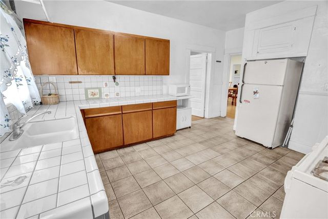 a kitchen with stainless steel appliances a refrigerator sink and cabinets