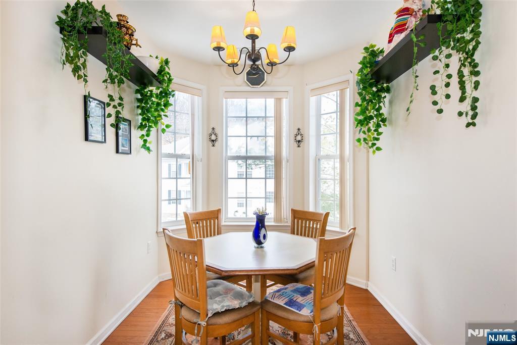 9 Cliff Road Woodland Park, NJ 07424 - Photo 11 of 25 a dining room with furniture a potted plant and a chandelier