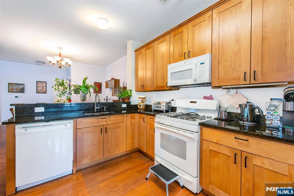 9 Cliff Road Woodland Park, NJ 07424 - Photo 13 of 25 a kitchen with stainless steel appliances granite countertop a stove a sink and a microwave