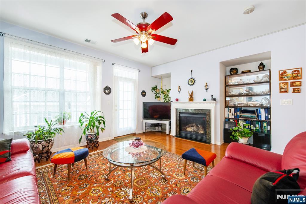 9 Cliff Road Woodland Park, NJ 07424 - Photo 18 of 25 a living room with furniture potted plant and a fireplace