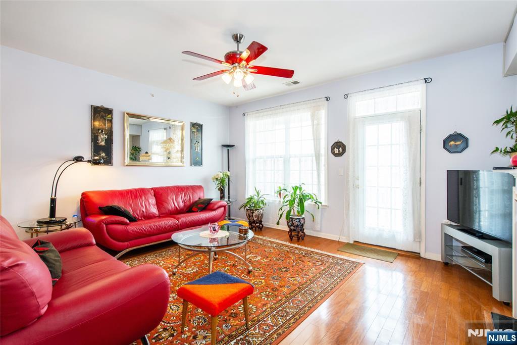 9 Cliff Road Woodland Park, NJ 07424 - Photo 19 of 25 a living room with furniture and a flat screen tv