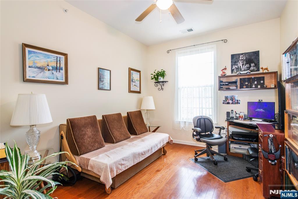 9 Cliff Road Woodland Park, NJ 07424 - Photo 6 of 25 a living room with furniture a rug and a lamp