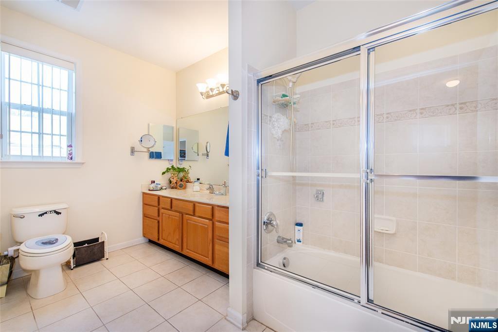 9 Cliff Road Woodland Park, NJ 07424 - Photo 9 of 25 a bathroom with a double vanity sink toilet and shower