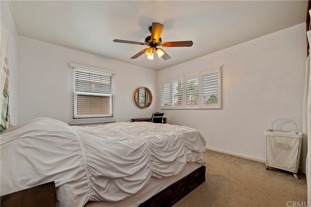 4140 St George Place Riverside, CA 92504 - Photo 19 of 29 a bedroom with a bed and a chandelier