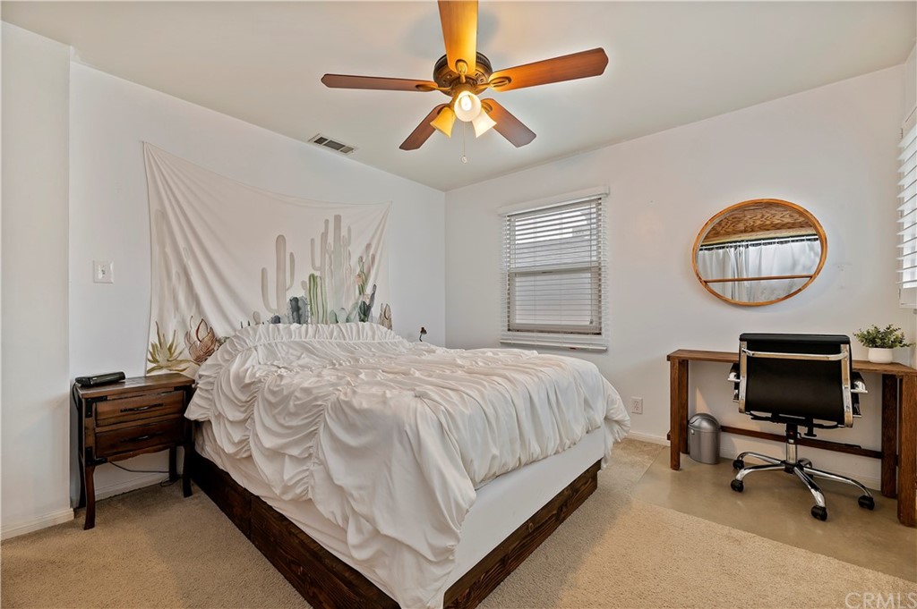 4140 St George Place Riverside, CA 92504 - Photo 20 of 29 a bedroom with a bed and a chandelier