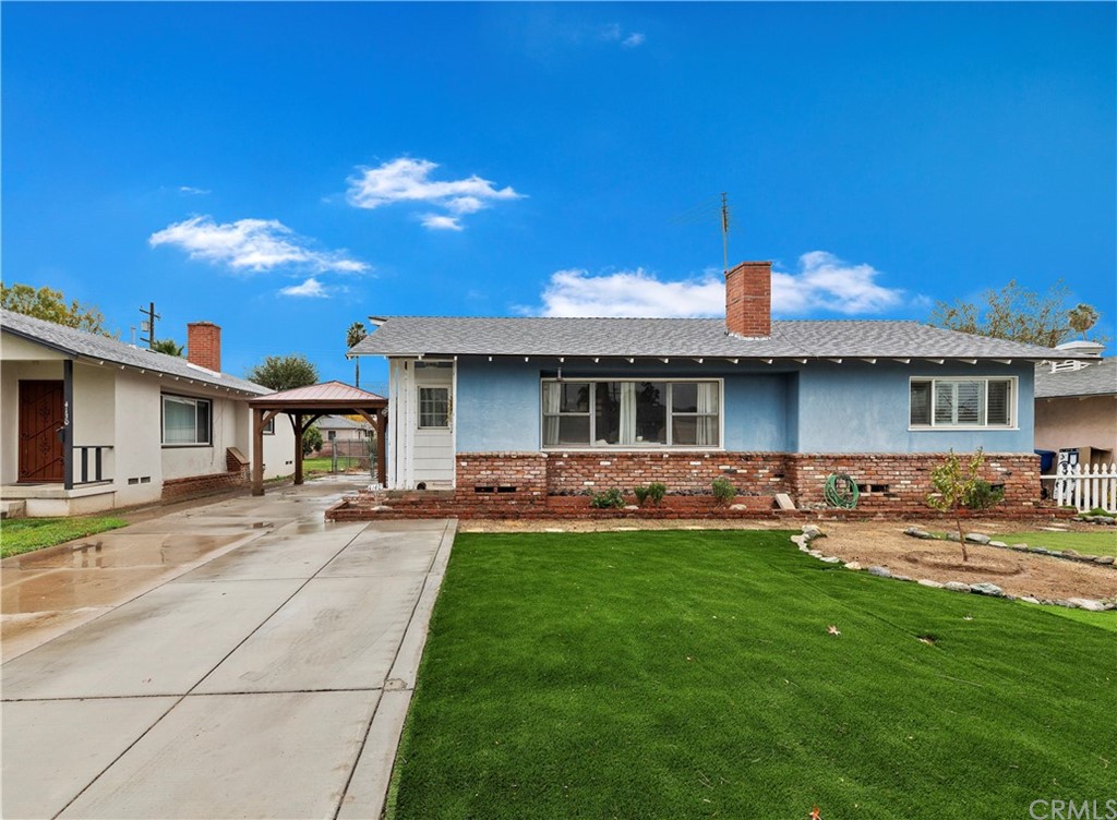 4140 St George Place Riverside, CA 92504 - Photo 3 of 29 a front view of a house with a yard