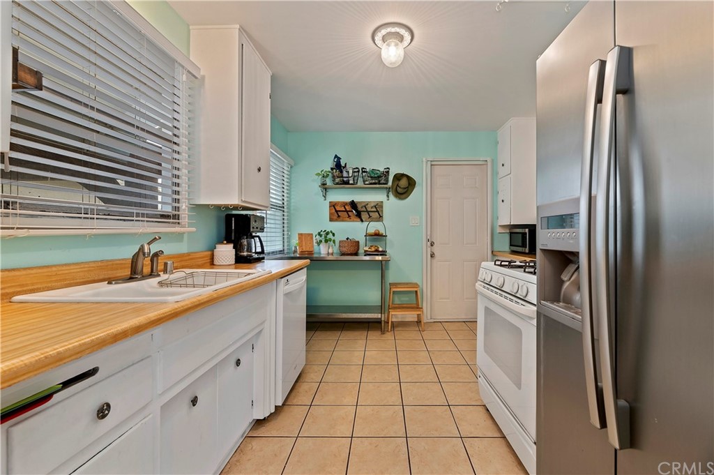 4140 St George Place Riverside, CA 92504 - Photo 24 of 29 a kitchen with stainless steel appliances a refrigerator sink and stove