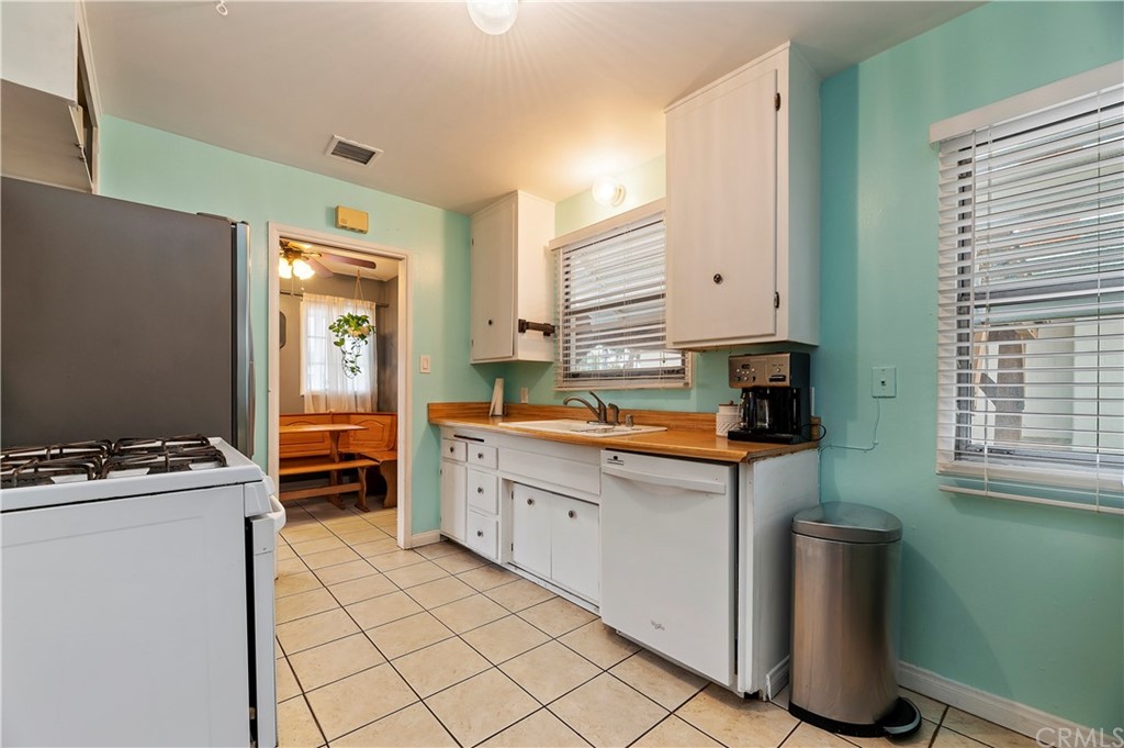 4140 St George Place Riverside, CA 92504 - Photo 26 of 29 a kitchen with stainless steel appliances granite countertop a stove a sink and a refrigerator