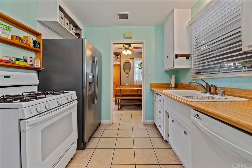 4140 St George Place Riverside, CA 92504 - Photo 27 of 29 a kitchen with stainless steel appliances granite countertop a refrigerator and a stove